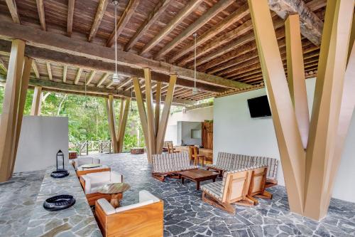 a living room with wooden ceilings and wooden furniture at The Explorean Cozumel All Inclusive in Cozumel