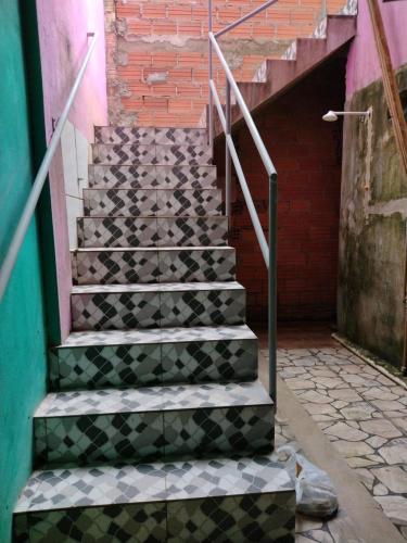 a set of stairs with black and white tiles at Pousada Sombra do Jambeiro in Alter do Chao