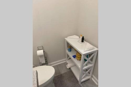 a bathroom with a white toilet and a sink at Entire residential home -Omaha in Omaha