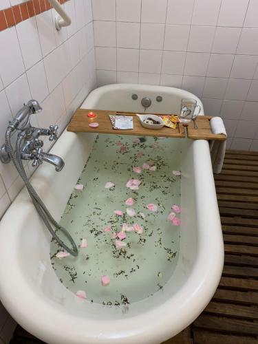 a bath tub with a sink with flowers on it at Hotel Boutique & Spa Puerto Natura in Valparaíso