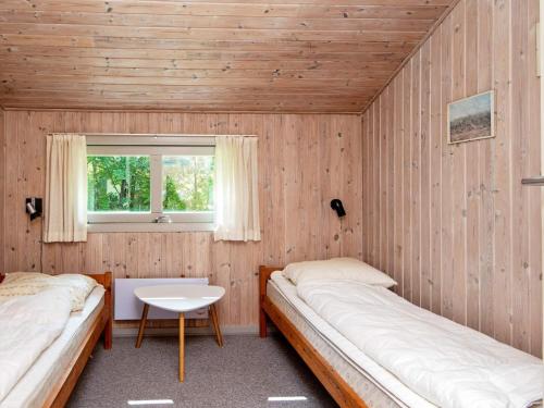 two beds in a room with a window at Luxury Retreat near Kvie So - By Traum Ferienwohnungen in Ansager