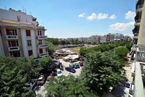 a city street with cars parked in a parking lot at Orestias Kastorias in Thessaloniki