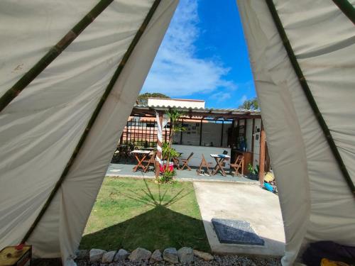 a view from inside a tent of a yard at Primitivo glamping buzios in Búzios