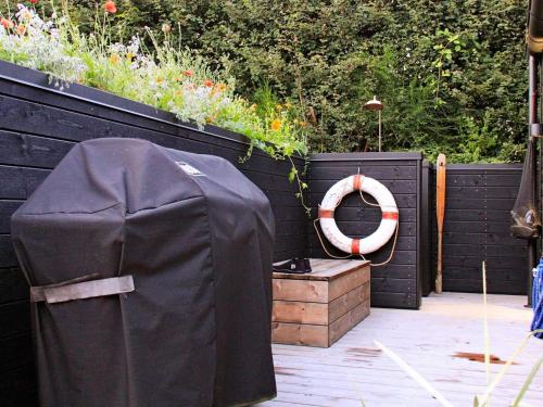 a backyard with a black fence and a wooden box at 4 person holiday home in S nder Stenderup in Sønder Stenderup