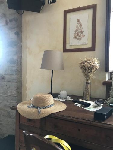 a hat sitting on top of a desk with a lamp at Radice Verde in Cissone