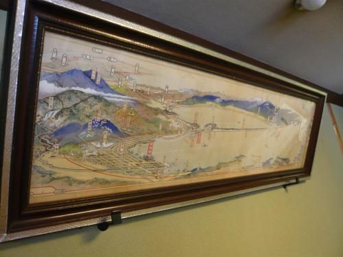 a picture of a painting hanging on a wall at Seikiro Ryokan Historical Museum Hotel in Miyazu