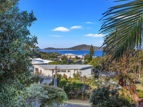 an image of a house with a view of the ocean at Island View Large Family Home Pool WI FI and Sweeping Views of Fingal in Fingal Bay