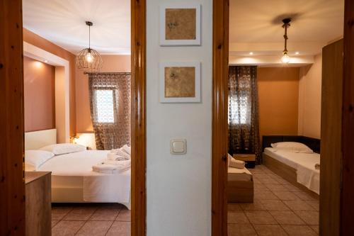 a hotel room with two beds and a bathroom at Magdalene's Premium Apartments in Ofrínion