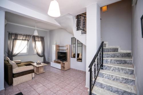a living room with a staircase and a couch at Magdalene's Premium Apartments in Ofrínion