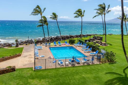 an overhead view of a swimming pool and the ocean at Kihei Surfside Resort #308 in Kihei