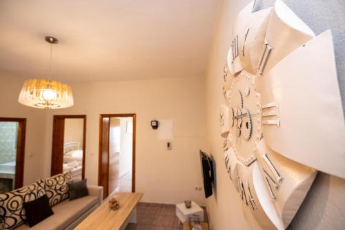 a living room with a clock on the wall at Magdalene's Premium Apartments in Ofrínion