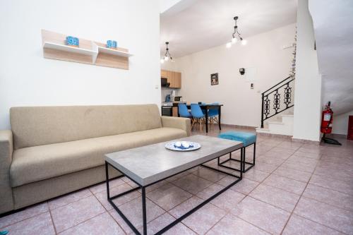 a living room with a couch and a table at Magdalene's Premium Apartments in Ofrínion