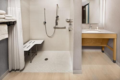 a bathroom with a shower and a sink at Hyatt Place Murfreesboro in Murfreesboro