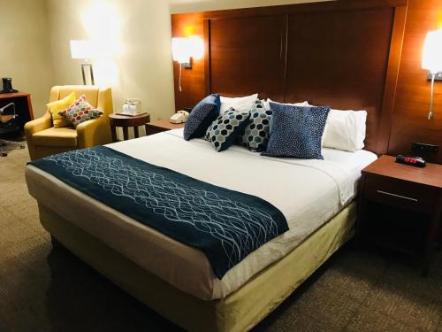 a hotel room with a large bed and a chair at Comfort Inn, Erie - Near Presque Isle in Erie