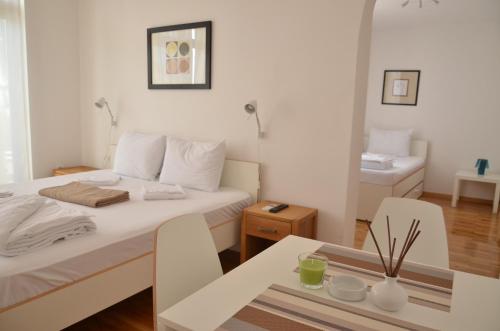 a room with two beds and a table with a dining room at Villa Katerina in Ohrid