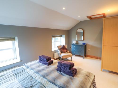 a bedroom with a large bed and a chair at The Green in Ripon