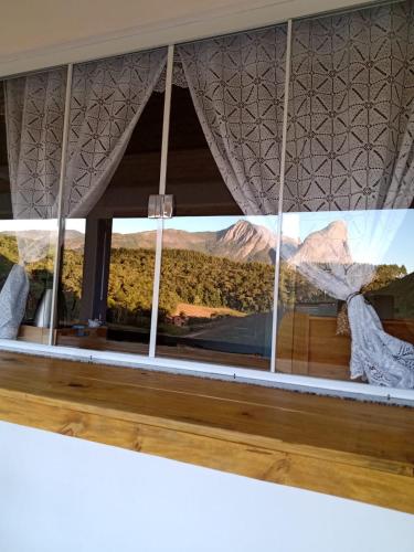 a view of the desert through a window at Encanto do Lagarto in Domingos Martins