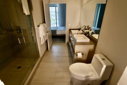 een badkamer met een toilet, een wastafel en een douche bij Luxury Two Bed Two Bath Beach Resort Condo 35 USD resort fee per day in Hollywood
