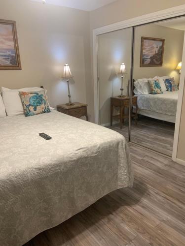 a hotel room with a bed and a mirror at Cozy comfortable & convenient in Pensacola