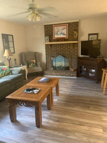 a living room with a coffee table and a fireplace at Cozy comfortable & convenient in Pensacola