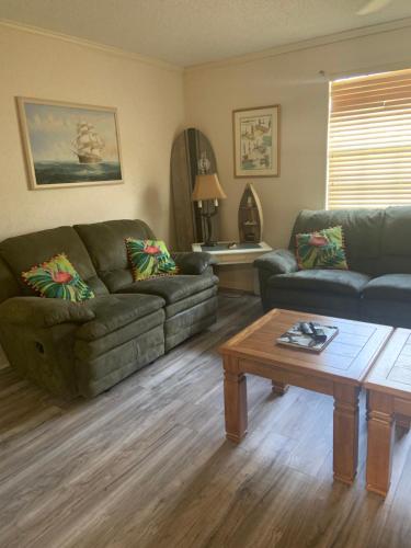 a living room with two couches and a coffee table at Cozy comfortable & convenient in Pensacola