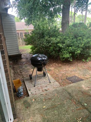 a black grill sitting outside of a house at Cozy comfortable & convenient in Pensacola