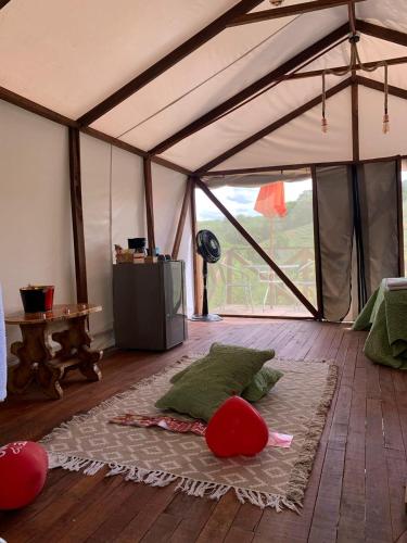 a room with a tent with pillows on the floor at Eco-Glamping Shalom in Mariquita