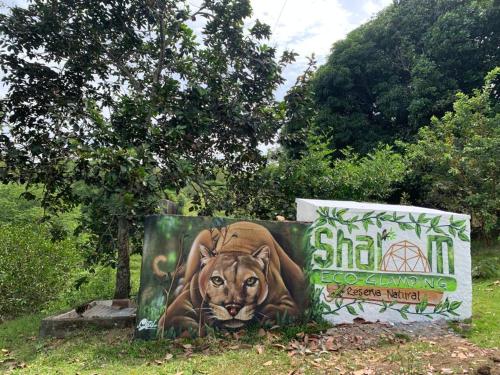 a sign with a picture of a lion on it at Eco-Glamping Shalom in Mariquita