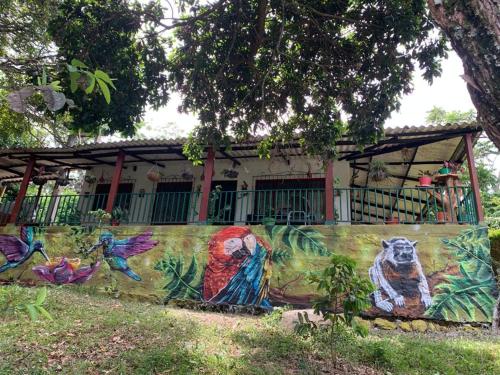 a painting on a wall in front of a house at Eco-Glamping Shalom in Mariquita