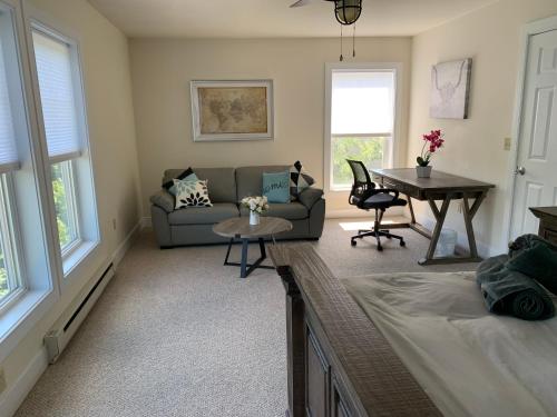 a living room with a couch and a table at New ! Slopeside Townhome : WFH, Ski, Dine & Hike in Tannersville