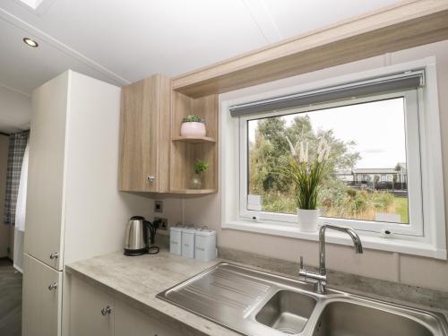 a kitchen with a sink and a window at 14 Fairways in Burnham on Sea