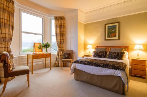 a hotel room with a bed and a window at The Arran Lodge & Arran Sleep Huts in Lamlash