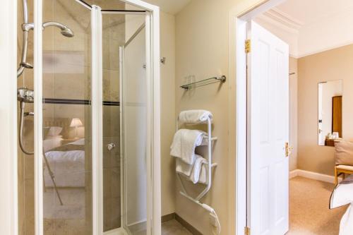 a bathroom with a shower with a glass door at The Arran Lodge & Arran Sleep Huts in Lamlash
