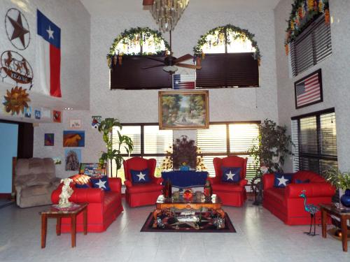 a living room with red couches and a table at Texas Inn Harlingen in Harlingen