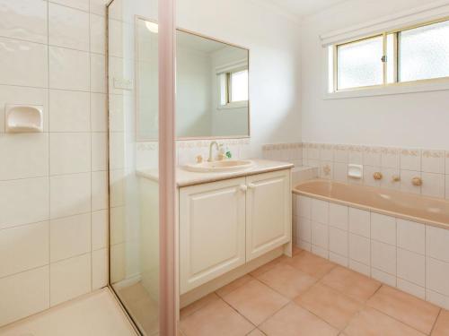 a bathroom with a shower and a sink and a tub at AMALFI - DROMANA.... in Dromana