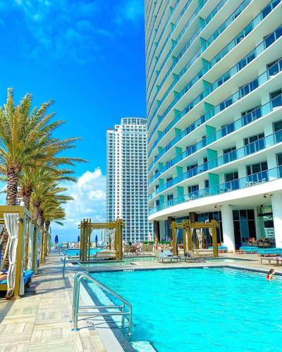 a large swimming pool next to a large building at Million Dollar View at Hyde Resort And Residences in Hollywood