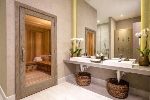 a bathroom with two sinks and a large mirror at Million Dollar View at Hyde Resort And Residences in Hollywood