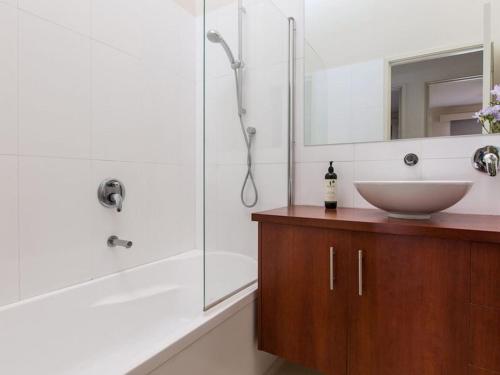 a bathroom with a sink and a shower at Seaviews Mornington in Mornington