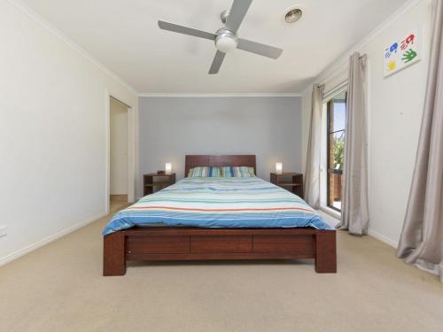 a bedroom with a bed and a ceiling fan at Sweetlands Sanctuary in Mount Martha