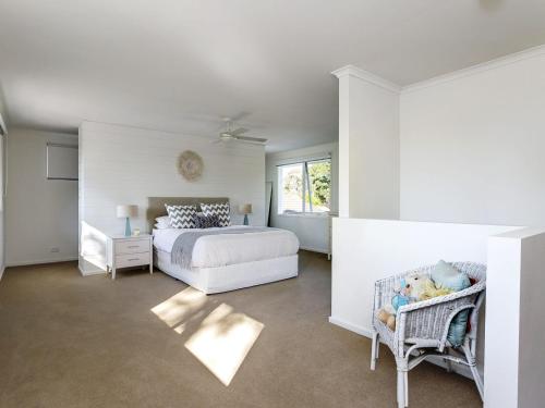 a bedroom with a bed and a crib in it at Allambea Mount Eliza in Mount Eliza