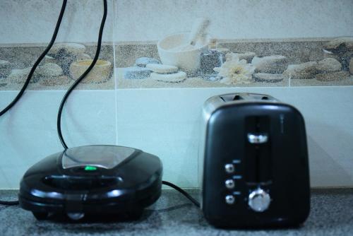 a toaster and a phone sitting on a counter at Srinagar Homes in Muzaffarabad