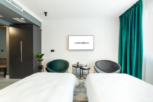a hospital room with two beds and two chairs at Campeador Inn in Cluj-Napoca