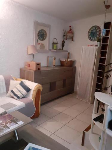 a living room with a couch and a table at L'Oustalet in Beaumes-de-Venise