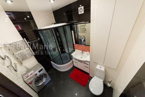 a bathroom with a shower and a toilet and a sink at PaulMarieApartments on Sovetskaya in Brest