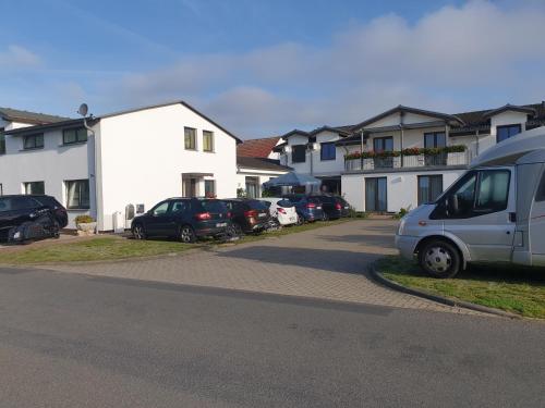a van parked next to a row of houses at Hotel-Pension Pastow Garni in Broderstorf