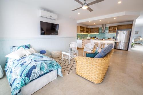a living room with a bed and a kitchen at Caba Break Holiday Apartments in Cabarita Beach