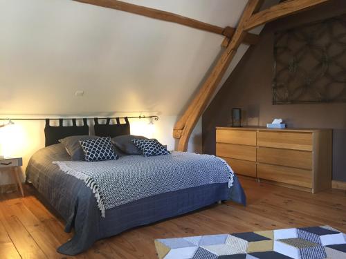 Un dormitorio con una cama tamaño king y una cómoda. en location de chambre en petit duplex proche de la baie de Somme, en Bellancourt