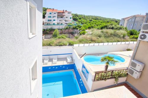 a view from the balcony of a hotel with a swimming pool at Villa Erna in Dubrovnik