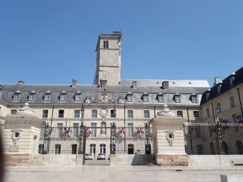a large building with a tower on top of it at Logis Saint Martin in Magny-lès-Villers