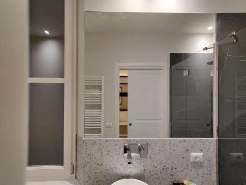 a bathroom with a sink and a mirror at La Bella Modena Centro in Modena